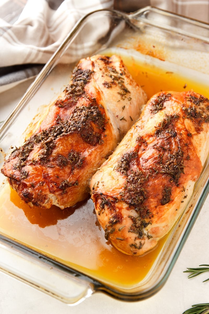 Herb roasted turkey breasts in a glass baking dish. 