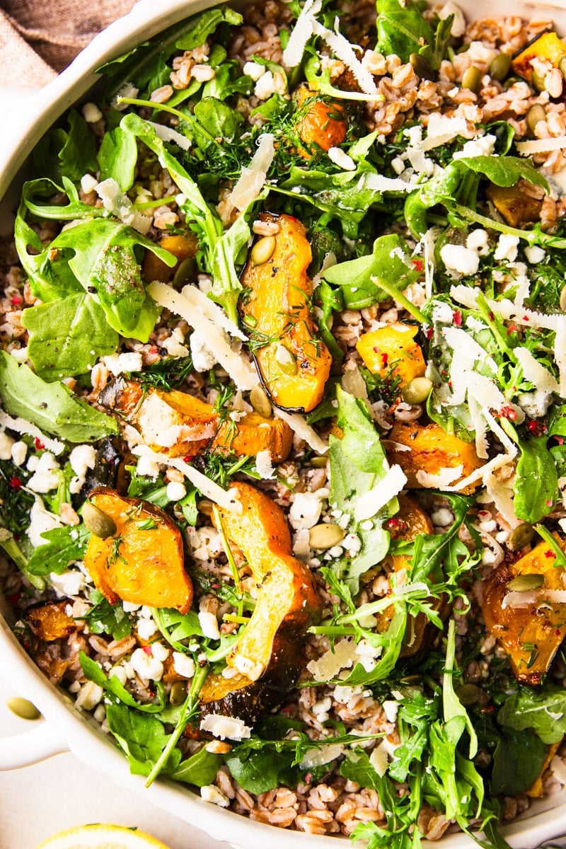 A close up of warm farro salad with roasted squash. 