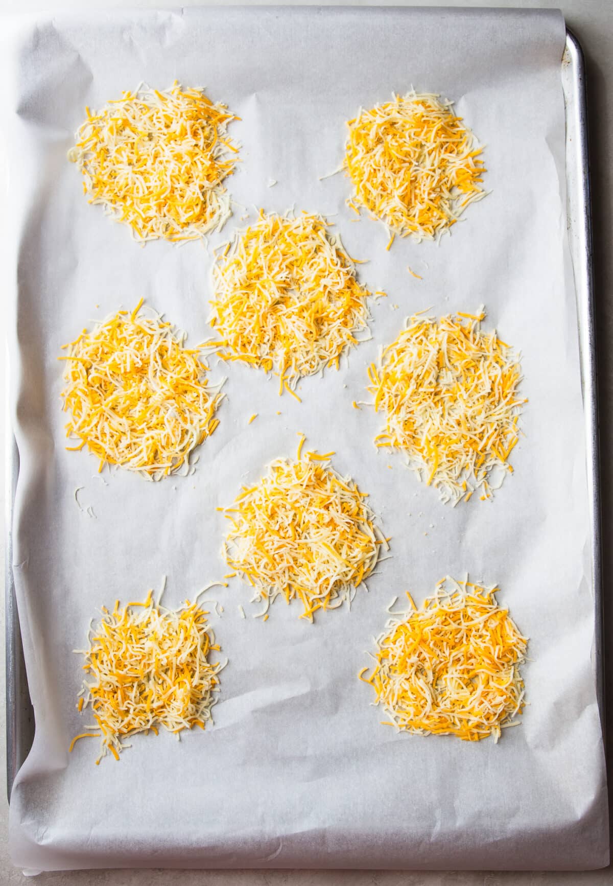 These Cheesy Onion Crisps bake up with crispy, lacy cheese and sweet roasted onions for an irresistible two-ingredient appetizer that's perfect for parties, snacking, or entertaining.