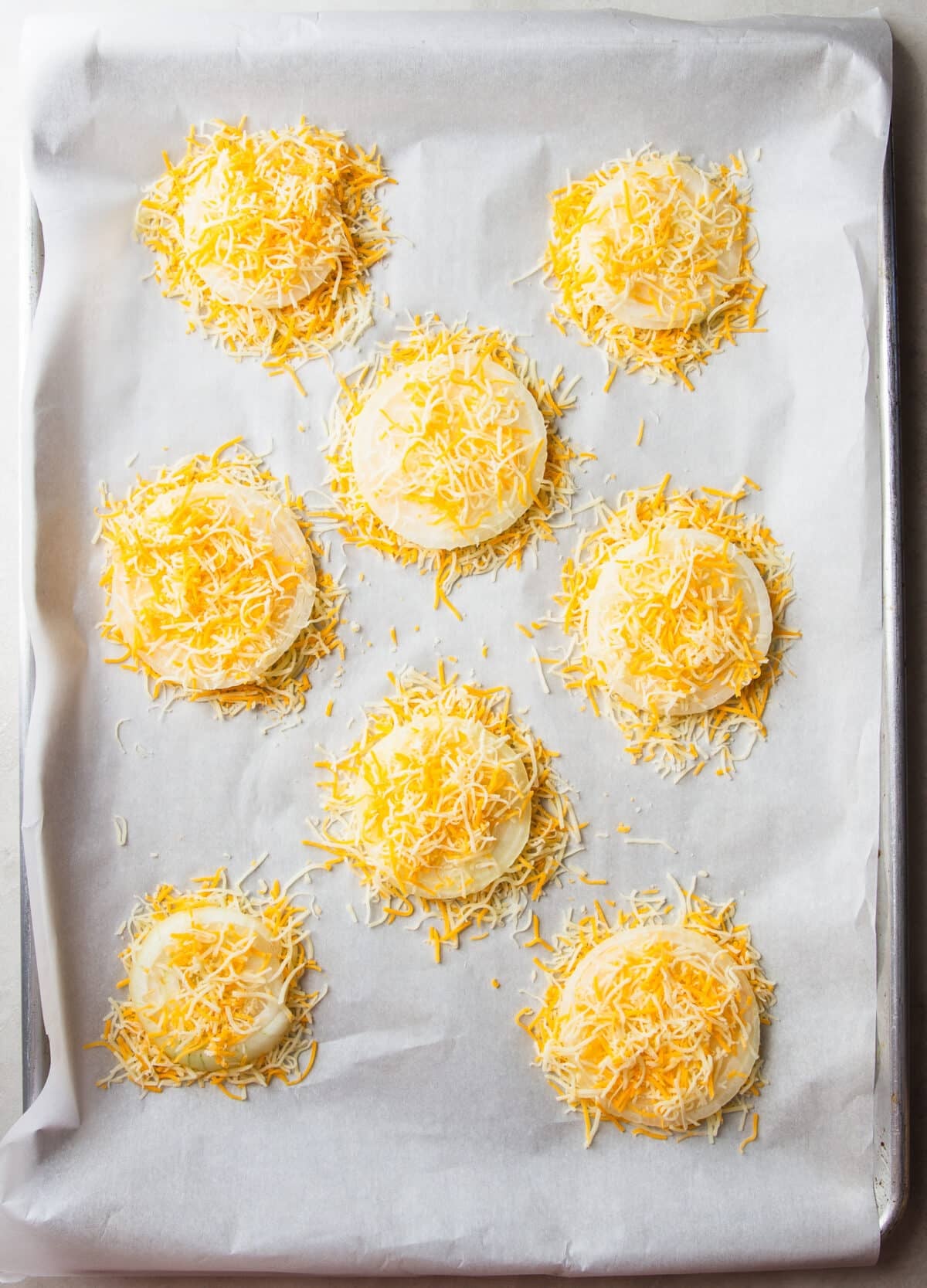 These Cheesy Onion Crisps bake up with crispy, lacy cheese and sweet roasted onions for an irresistible two-ingredient appetizer that's perfect for parties, snacking, or entertaining.