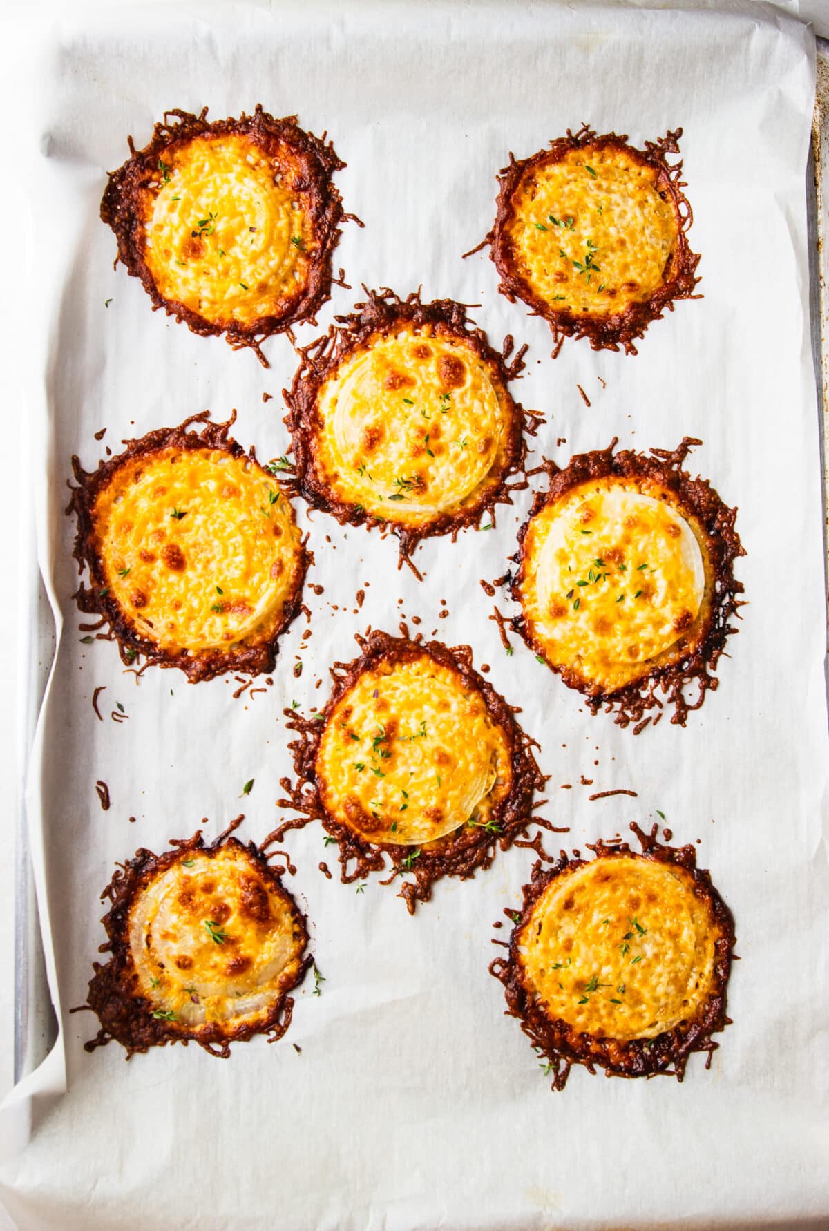 These Cheesy Onion Crisps bake up with crispy, lacy cheese and sweet roasted onions for an irresistible two-ingredient appetizer that's perfect for parties, snacking, or entertaining.