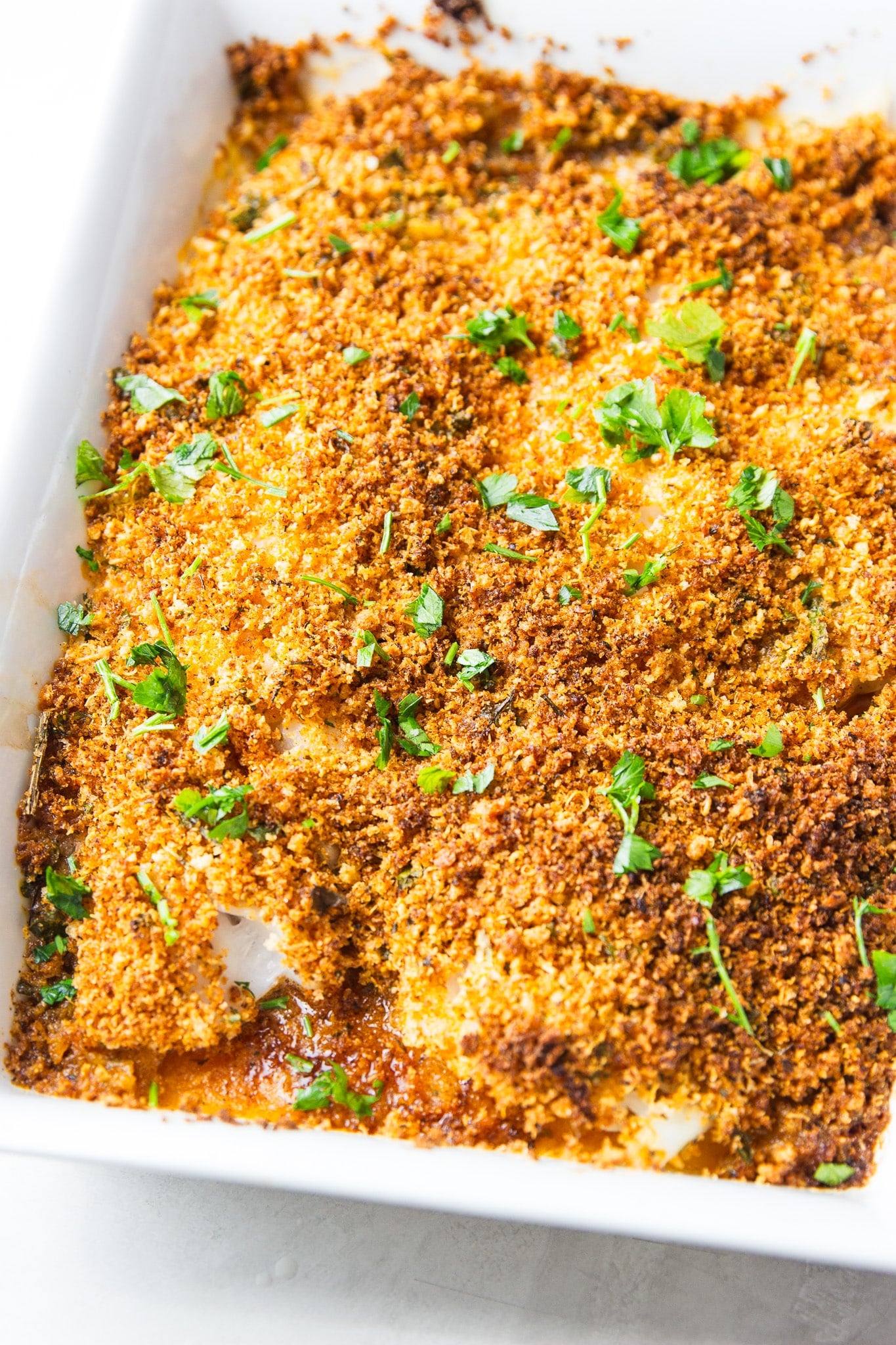 This Garlic Butter Parmesan Crusted Haddock is baked with buttery garlic, crispy Parmesan panko, and fresh herbs for an easy weeknight seafood dinner.