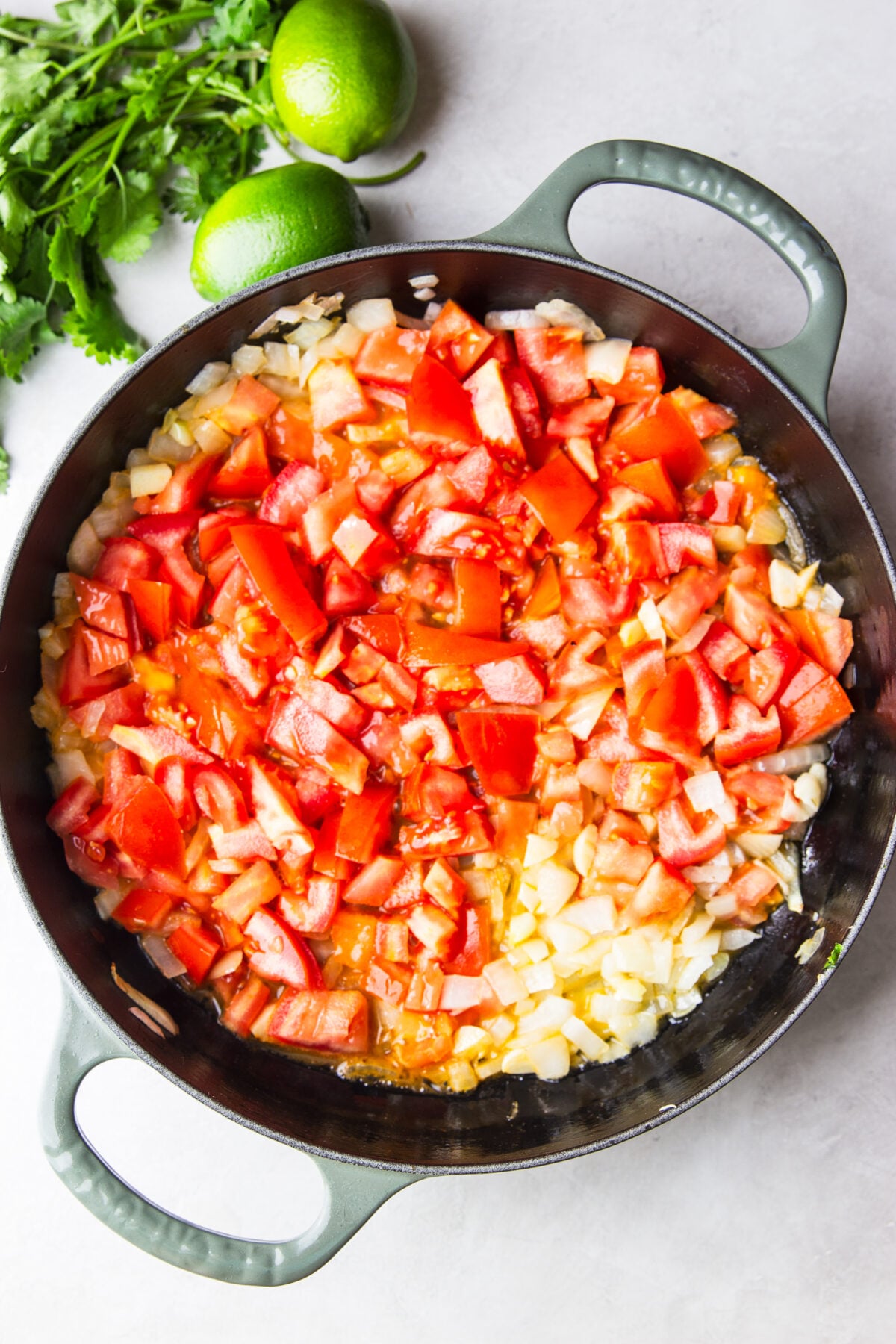 skillet with sautéed onions and tomatoes