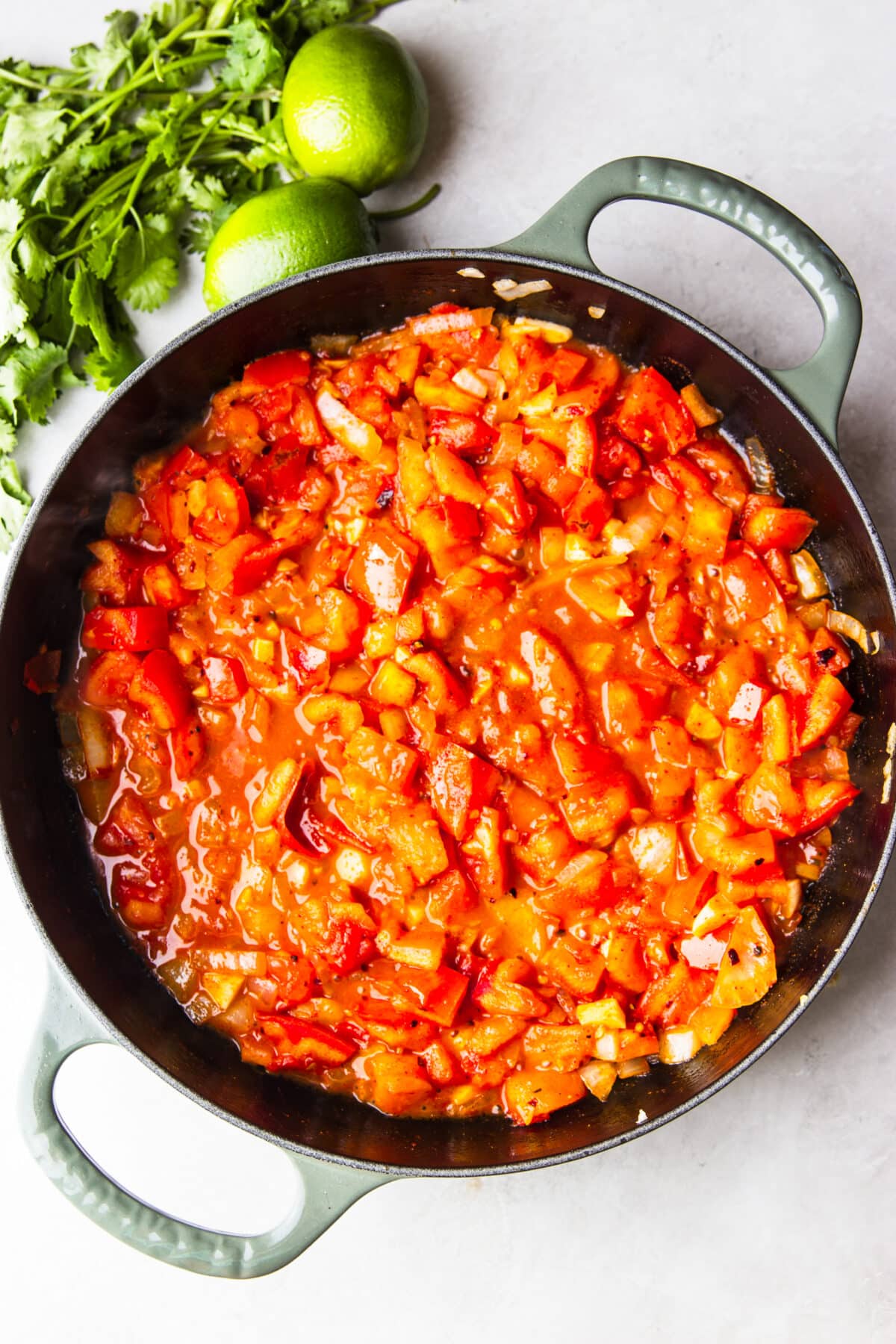 skillet with sautéed onions and tomatoes