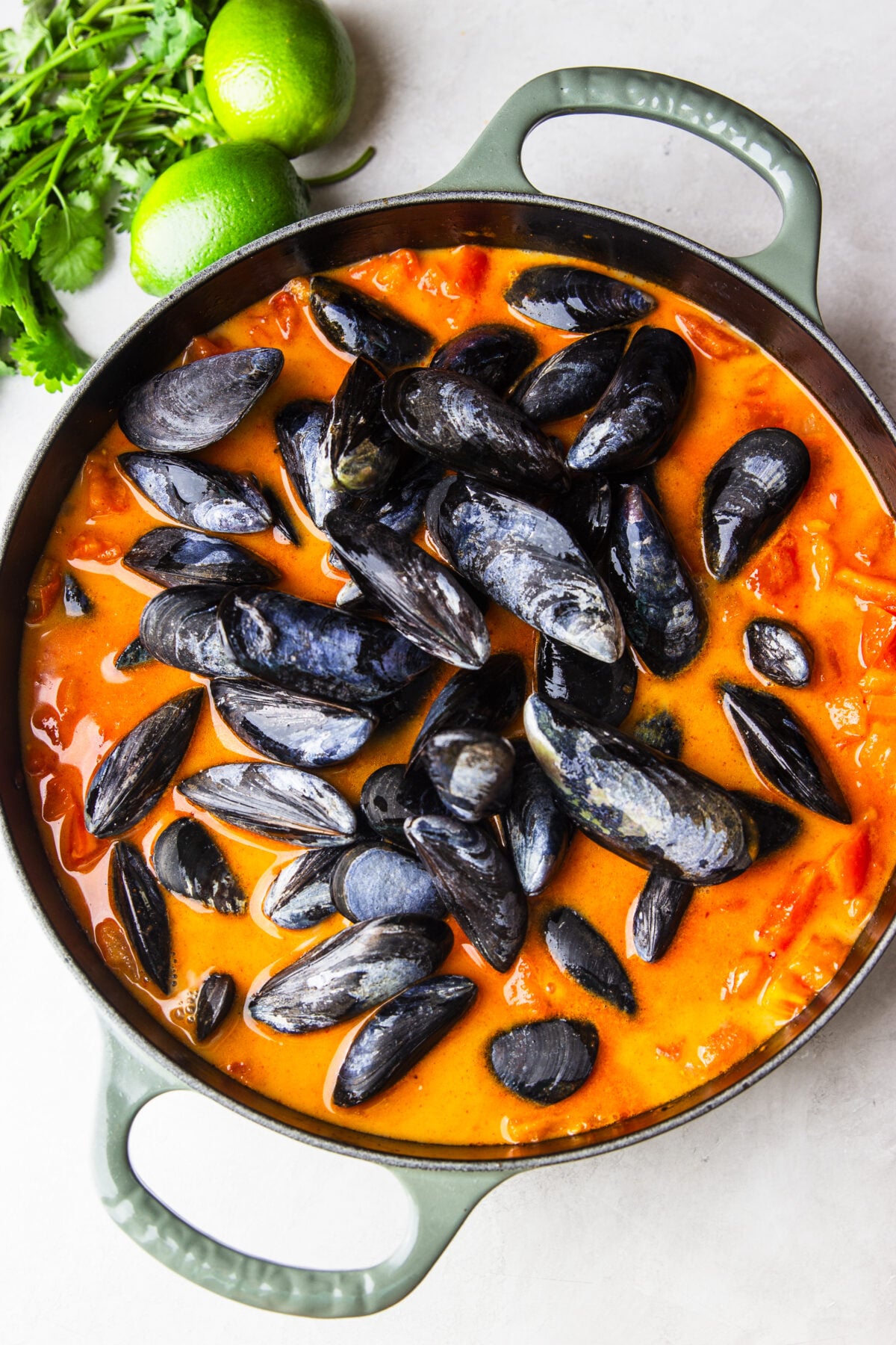 Tender mussels simmered in a flavorful tomato coconut broth with garlic, saffron, and fresh cilantro. This easy Brazilian-inspired seafood dinner is ready in just 30 minutes