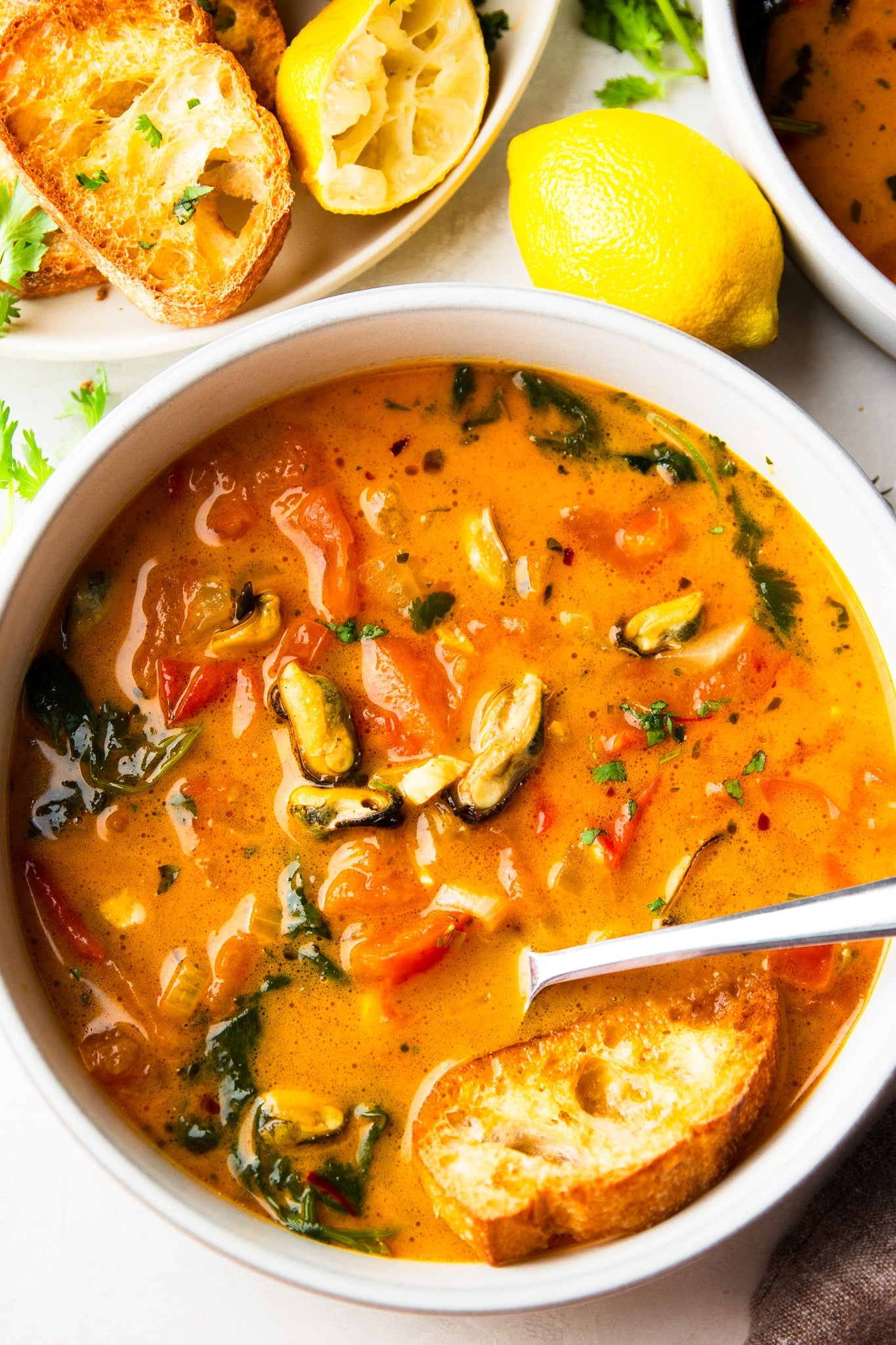 Tender mussels simmered in a flavorful tomato coconut broth with garlic, saffron, and fresh cilantro. This easy Brazilian-inspired seafood dinner is ready in just 30 minutes