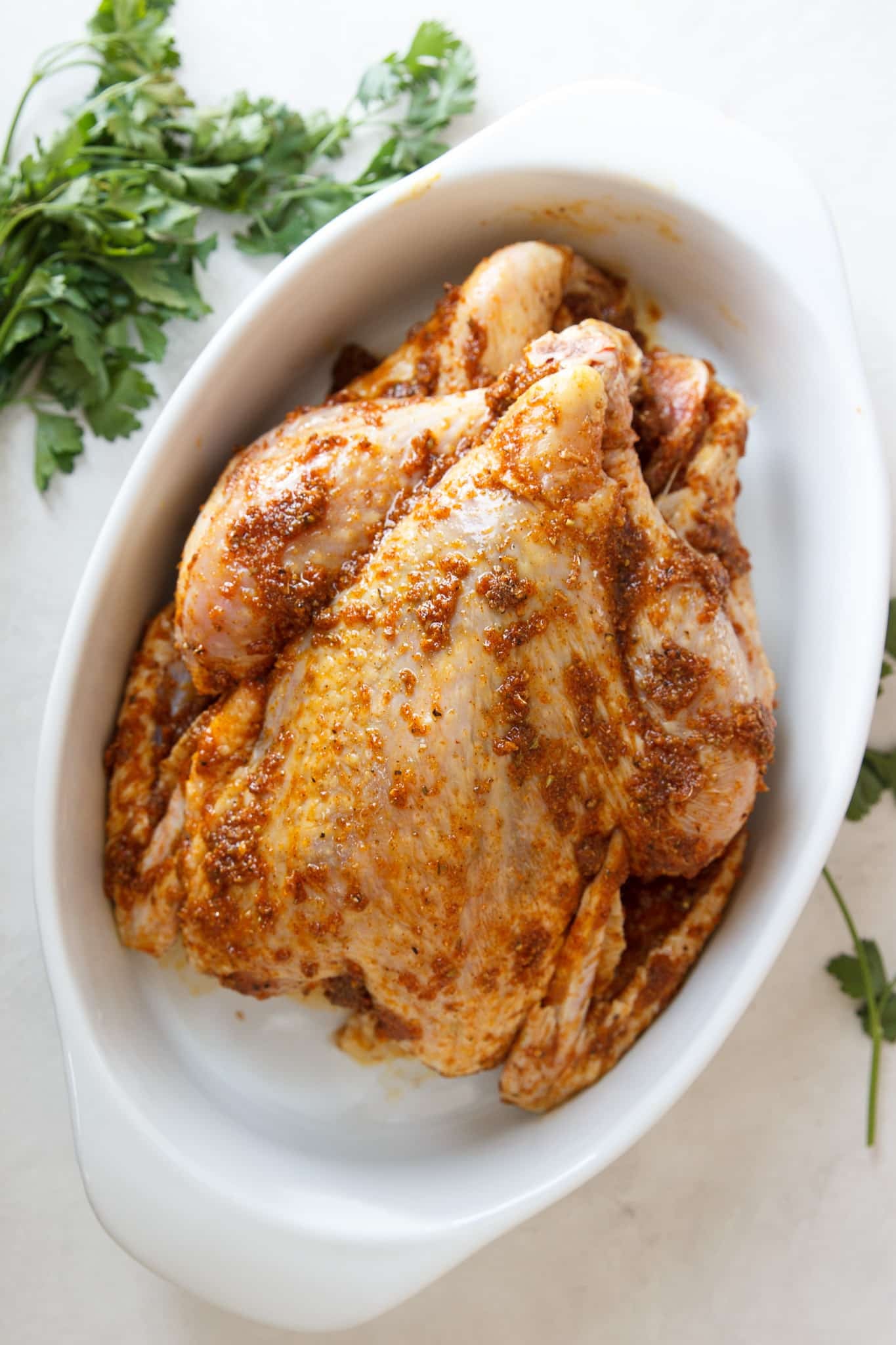 seasoned whole chicken in a baking dish