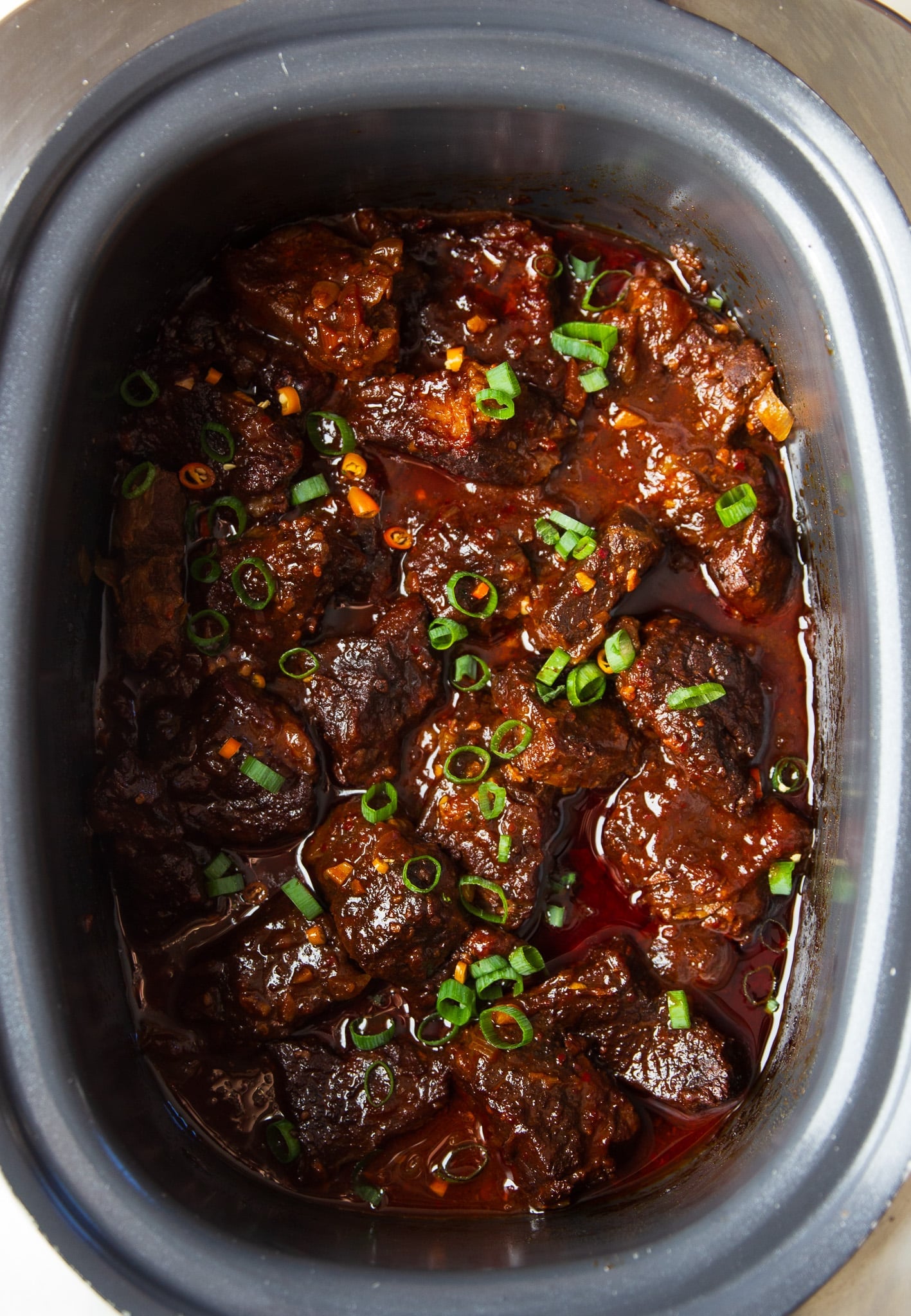 Slow Cooker Hot Honey Chili Beef made with tender beef chuck, chili crunch, garlic, and a rich sweet-spicy sauce. Easy to make and perfect over rice.