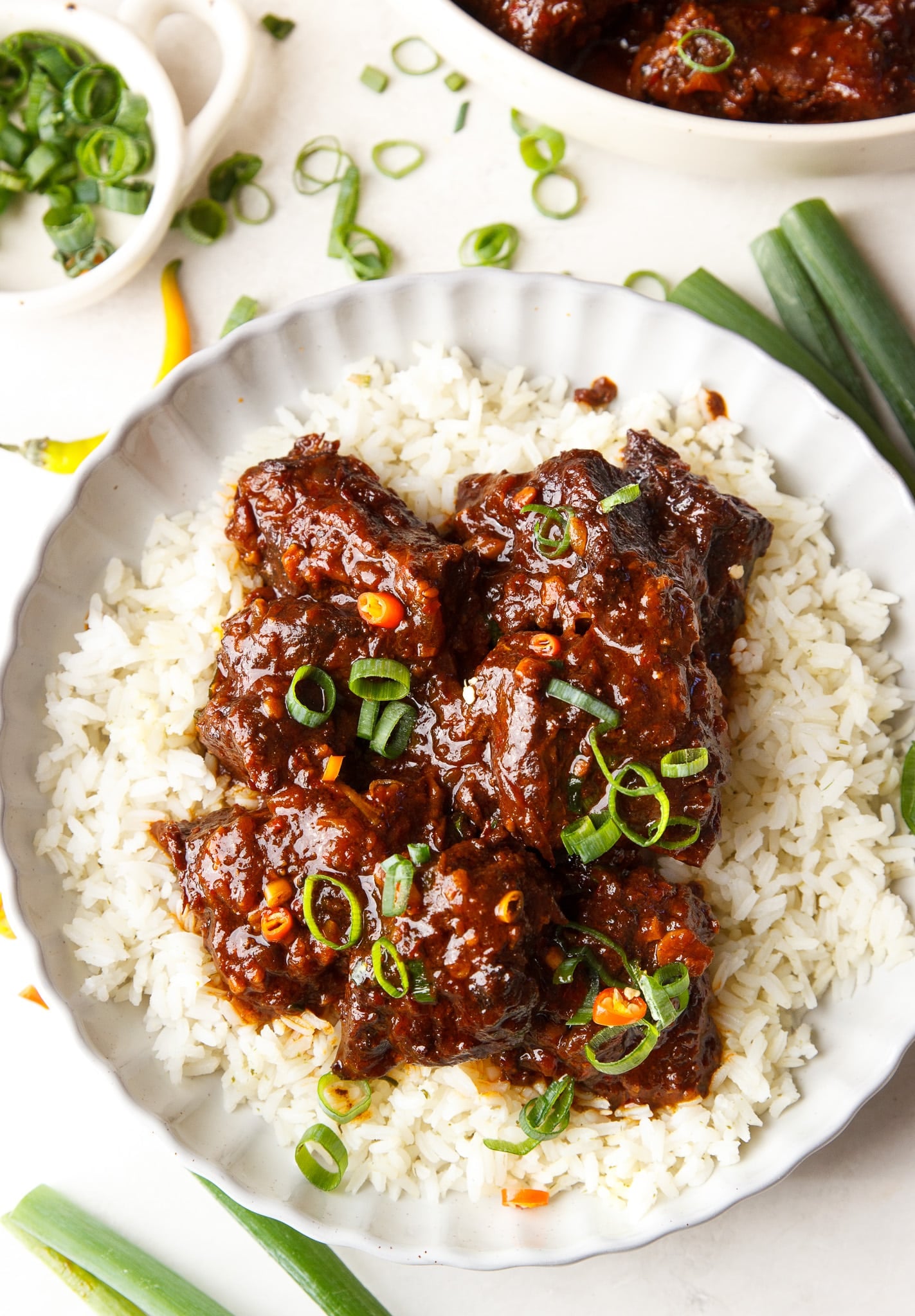 Hot honey chili beef chunks served over white rice topped with scallions