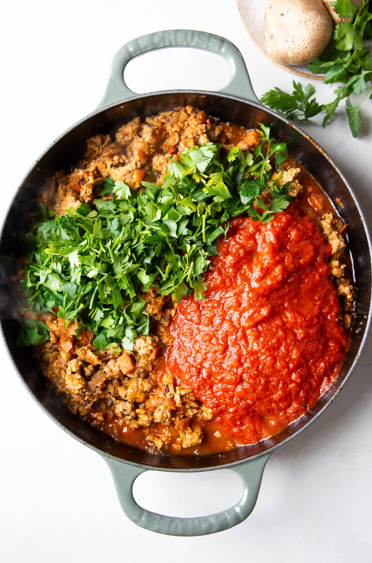red sauce with parsley and ground turkey in a skillet