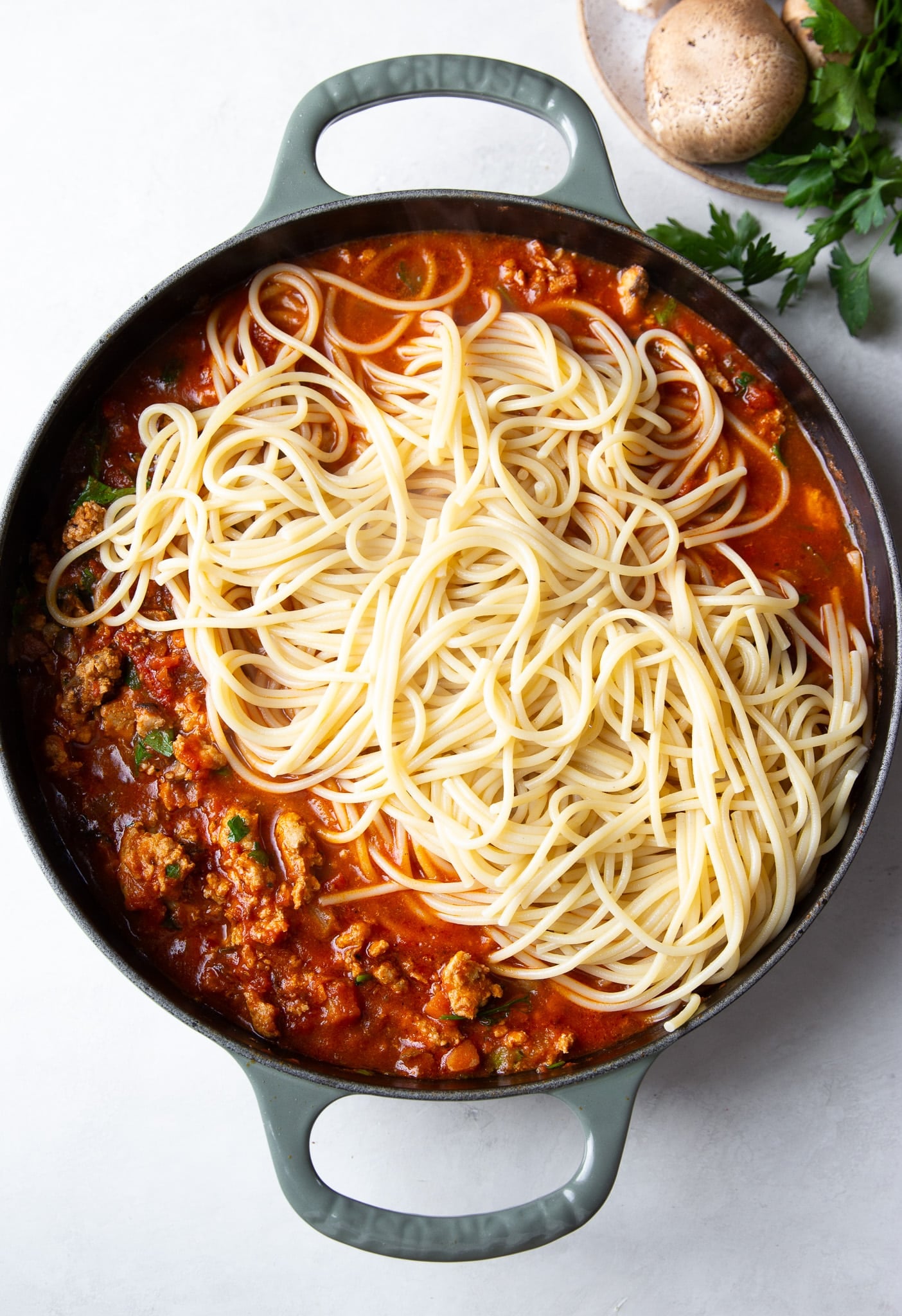 spaghetti and ground turkey with red sauce in a skillet